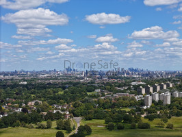 Drone image of London skyline with blue skies in the background.